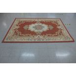 A red ground rug, 278 x 189cms