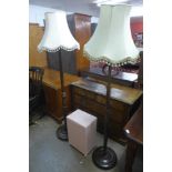 Two mahogany standard lamps and a wicker linen box
