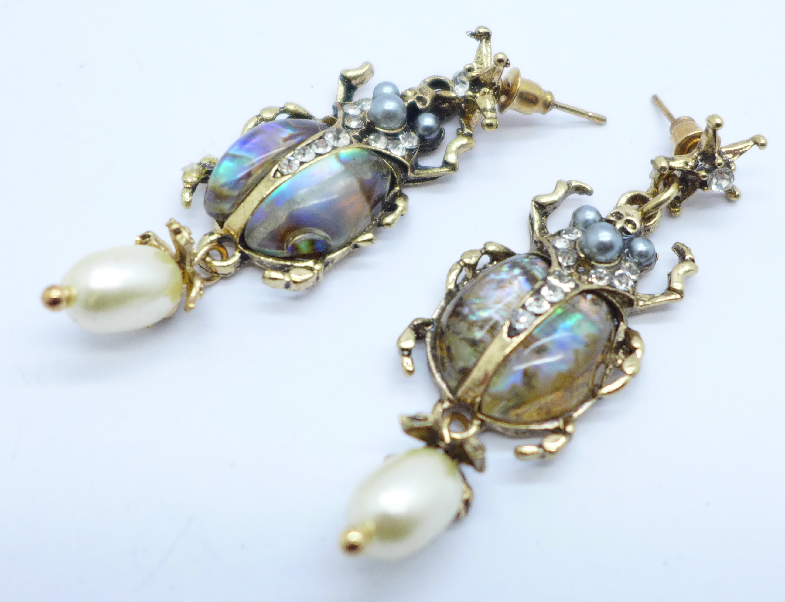 A pair of scarab beetle earrings