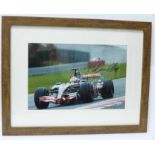 A framed signed photograph of Lewis Hamilton in the McLaren (Note: this was Lewis's autograph when