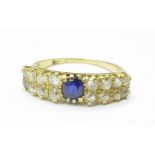 A yellow metal, sixteen stone diamond and single sapphire ring, mark worn, (tests as 18ct gold),