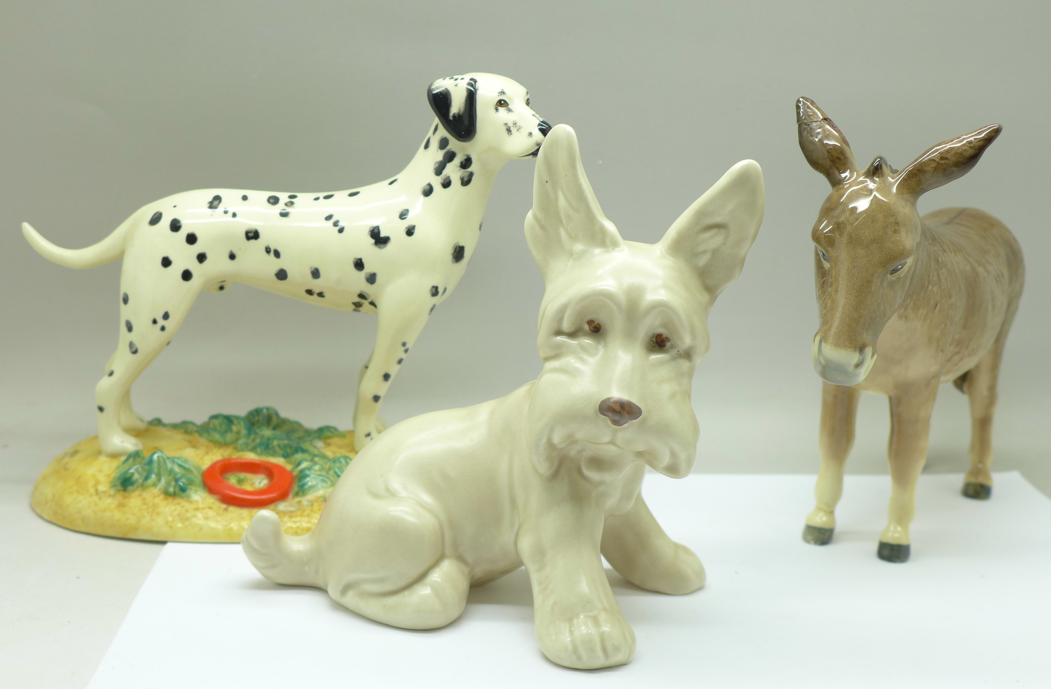 A Royal Doulton Dalmatian, a Beswick donkey and a Sylvac dog