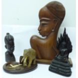 Two African carved heads, a carved elephant match holder and ashtray and a carved Thai deity