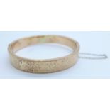 An Edwardian 9ct gold bangle, Chester 1908, 13.7g, a/f, dented