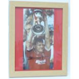 A framed signed photograph of Stuart Pearce lifting League Cup trophy