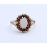A 9ct gold, opal and garnet ring, 1.9g, M