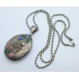 A Victorian silver locket with raised coloured enamel flowers and a seed pearl bird, Birmingham