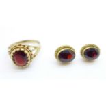 A 9ct gold and garnet ring, P, and a similar pair of earrings, 5.8g