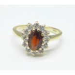 A 9ct gold, garnet and cubic zirconia cluster ring, 2.4g, M