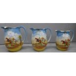 A set of three graduated hunting scene jugs by Falcon Ware, largest cracked