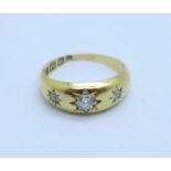 An 18ct gold, three stone diamond ring, Birmingham 1900, 3.4g, J