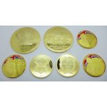 Seven gold plated commemorative medallions; two large 90th Birthday of H.M. Queen Elizabeth II,