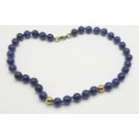 A lapis lazuli necklace with 9ct gold fastener