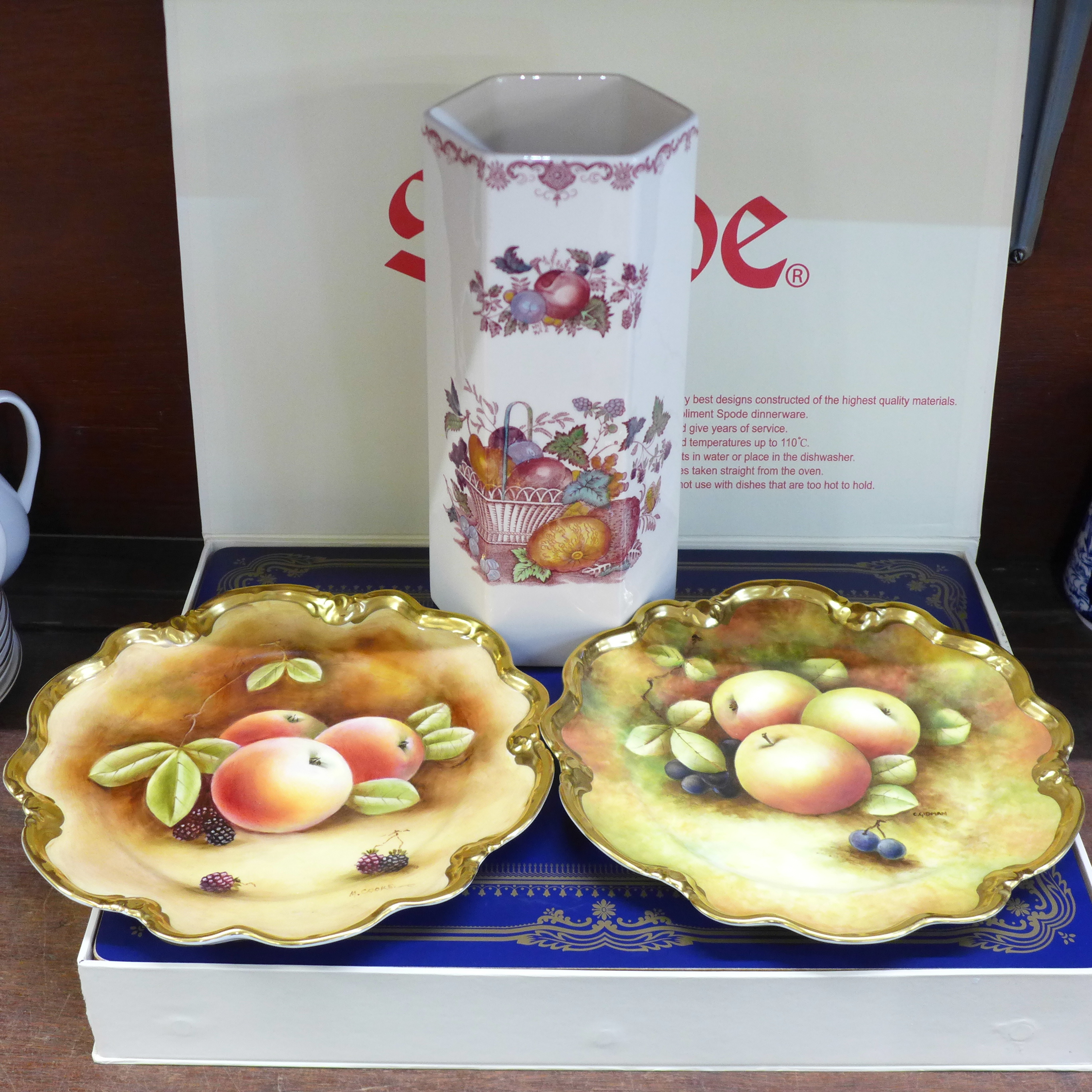 Two Coalport plates decorated with fruit, hand painted by Carole Gidman, a Mason's fruit basket vase