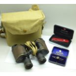 A pair of WWII military issue binoculars, Bino Prism No 2 x6, No 47302, a Wenger Swiss Army knife,