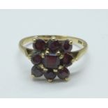 A 9ct gold and garnet nine stone ring, 2.7g, R