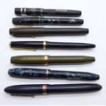 Seven fountain pens including Swan, Conway Stewart, etc., six with 14ct gold nibs, some a/f
