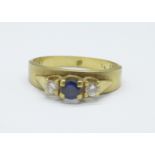 An 18ct gold, three stone diamond and sapphire ring, 3.9g, N