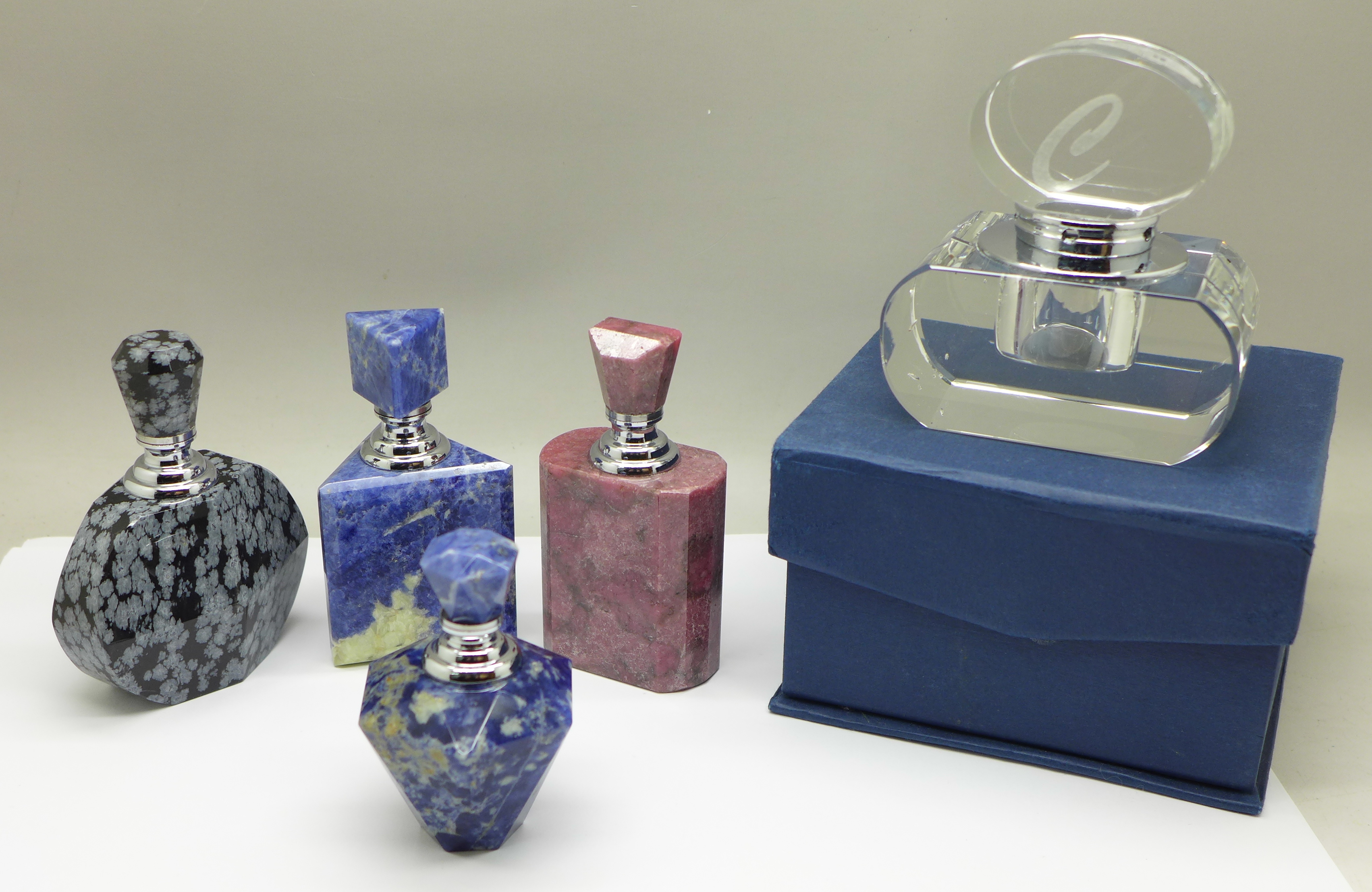 A collection of five perfume bottles, boxed