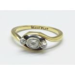 An 18ct gold, platinum set, rose cut three stone diamond ring with oval centre stone, 3g, M