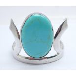 A large silver bangle set with turquoise, double hinged, chips to the edge of the turquoise