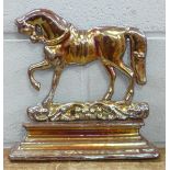 A cast metal horse doorstop