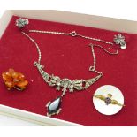 An Art Deco silver and marcasite necklace, an amber brooch, an RAF brooch and a pair of silver and