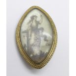 A Georgian mourning brooch, the image depicting a lady waving off a sailing ship, 37mm x 22mm