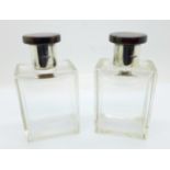 A pair of Art Deco silver and tortoiseshell topped glass scent bottles, with inner stoppers,