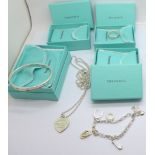 A Tiffany & Co. silver bangle, pendant and chain and ring, boxed, and a Sabo charm bracelet, ring