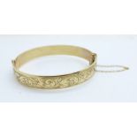 A '1/5th 9ct rolled gold' bangle