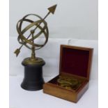 A reproduction brass compass, boxed and an armillary