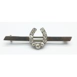 A diamond set horseshoe brooch, (tests as silver)