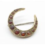 A 9ct gold and garnet crescent brooch, Chester 1914, 2.3g