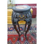 A Chinese carved padouk wood and marble topped jardiniere stand