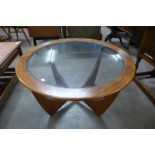 A G-Plan Astro teak and glass topped circular coffee table (chip to glass)