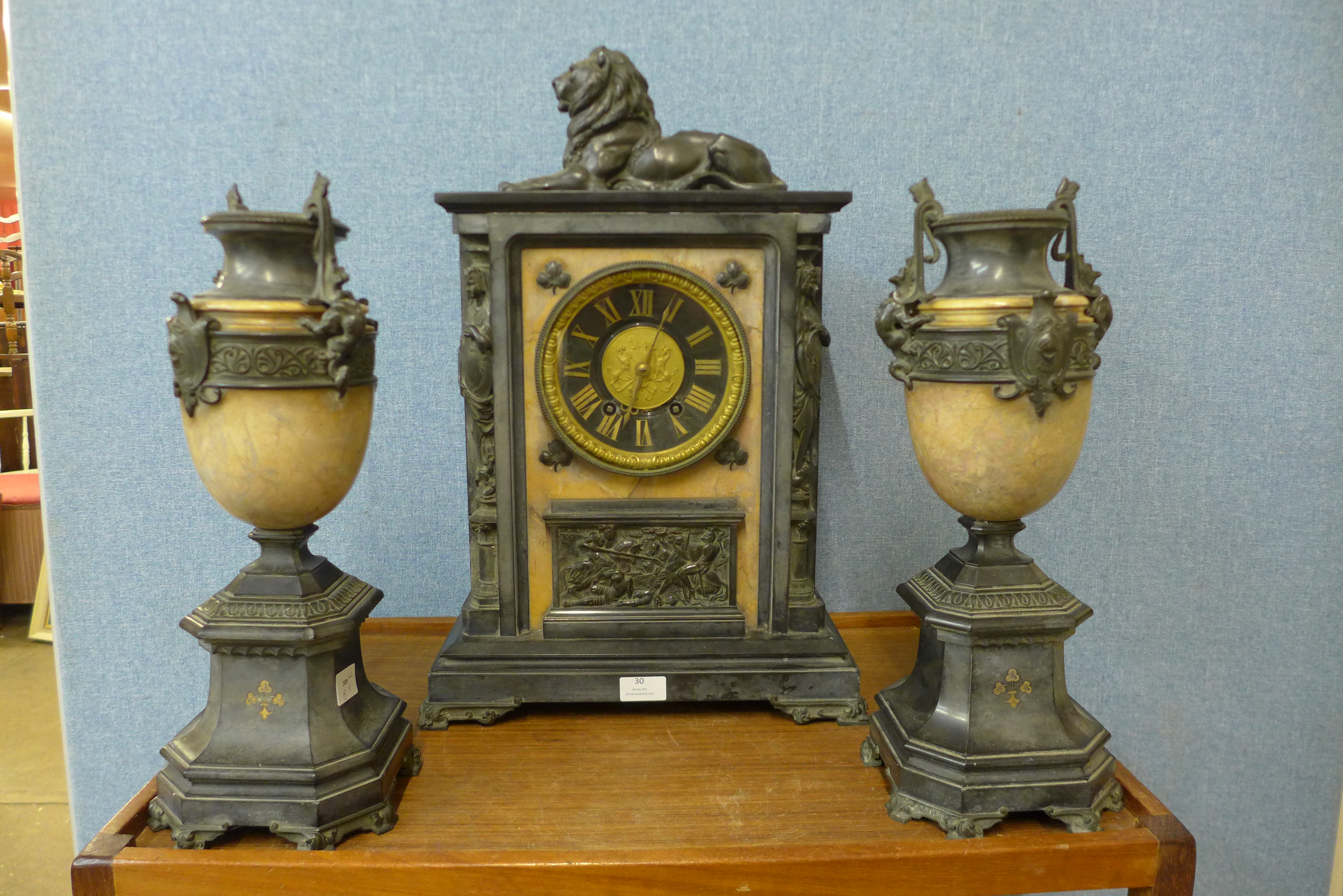 A 19th Century French Belge noir clock garniture