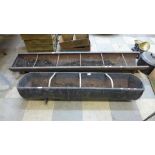 Two cast iron feeding troughs