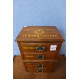 An early 20th Century walnut four drawer counter top haberdashery shop cabinet, bearing J&P Coates