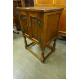 A small Old Charm oak two door cabinet