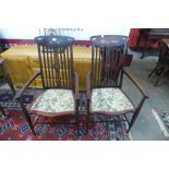 A pair of Arts and Crafts inlaid mahogany elbow chairs
