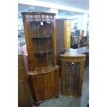 A yew wood serpentine freestanding corner cabinet and one other