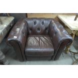 A brown faux leather Chesterfield club chair, 71cms h, 103cms w, 87cms d