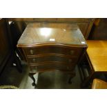 A small mahogany serpentine chest of drawers