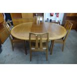 A Nathan teak extending dining table and four chairs