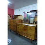 A teak chest of drawers and matching dressing table