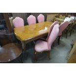 An Epstein style walnut dining table and six chairs, a/f