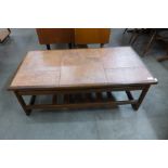 A teak and tiled top coffee table