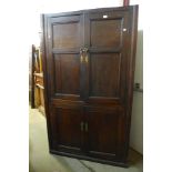 A George III oak freestanding corner cupboard