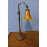 A brass adjustable desk lamp